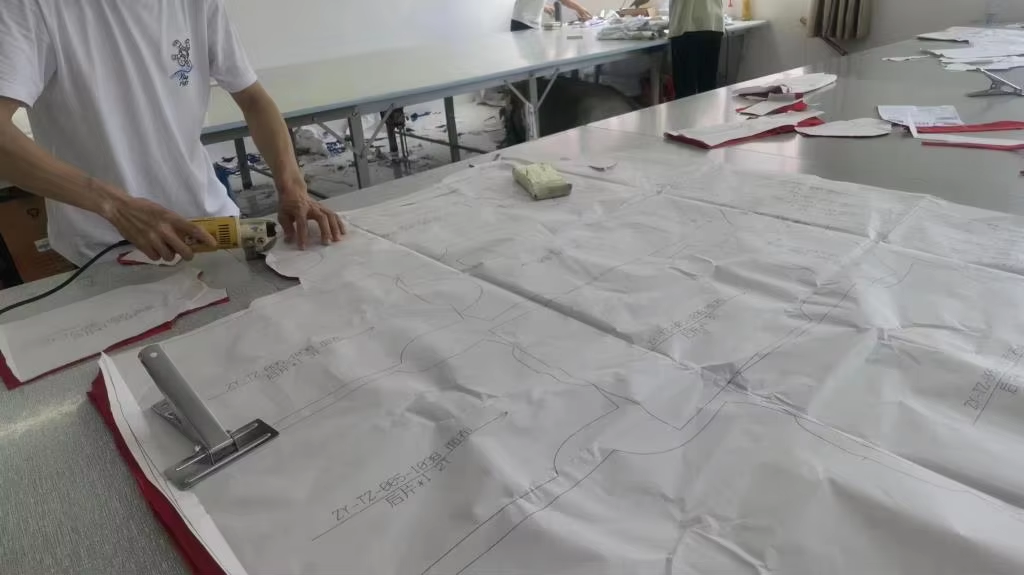 Team preparing garment pattern pieces for cutting