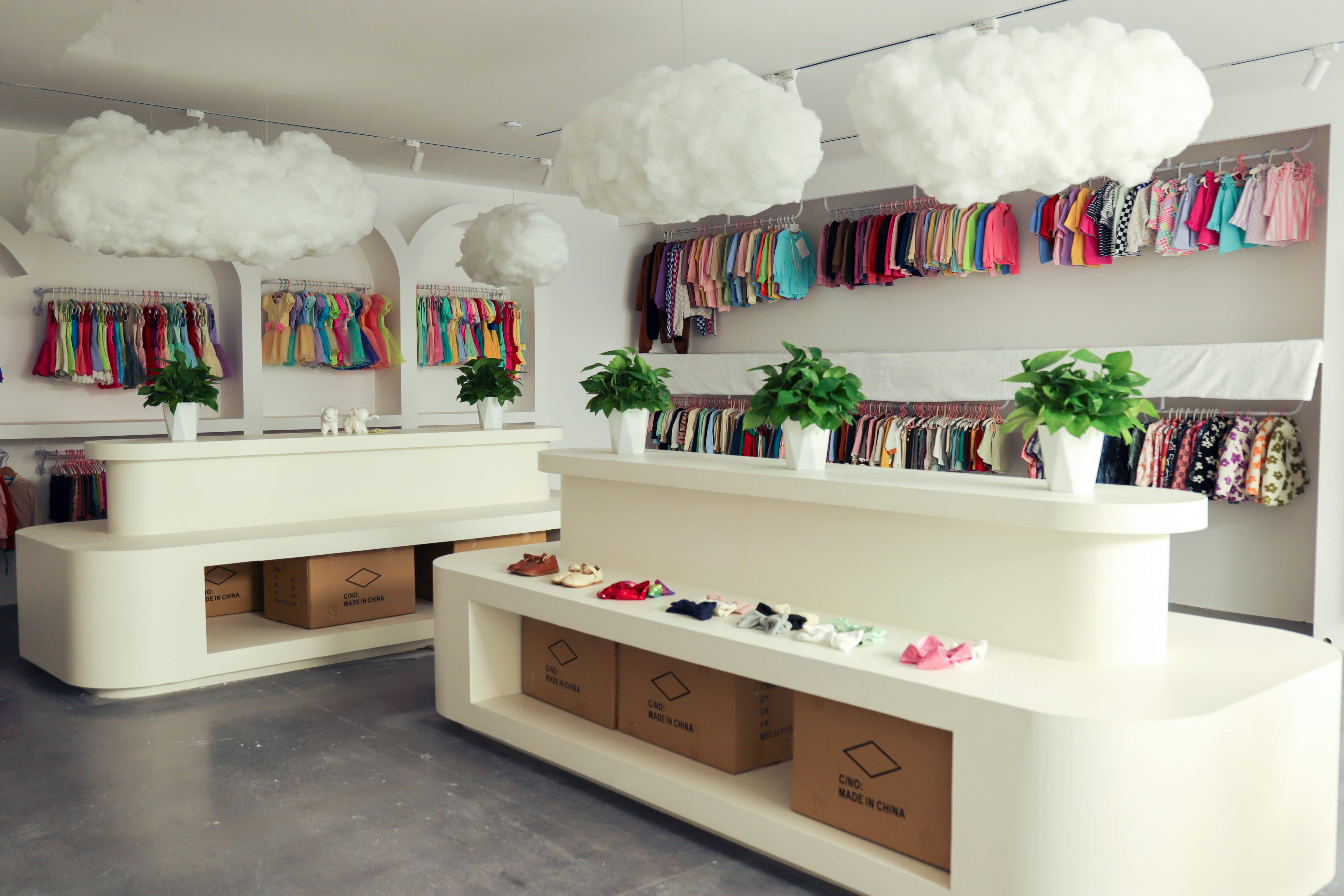 Kidswear sample showroom with garments displayed on racks