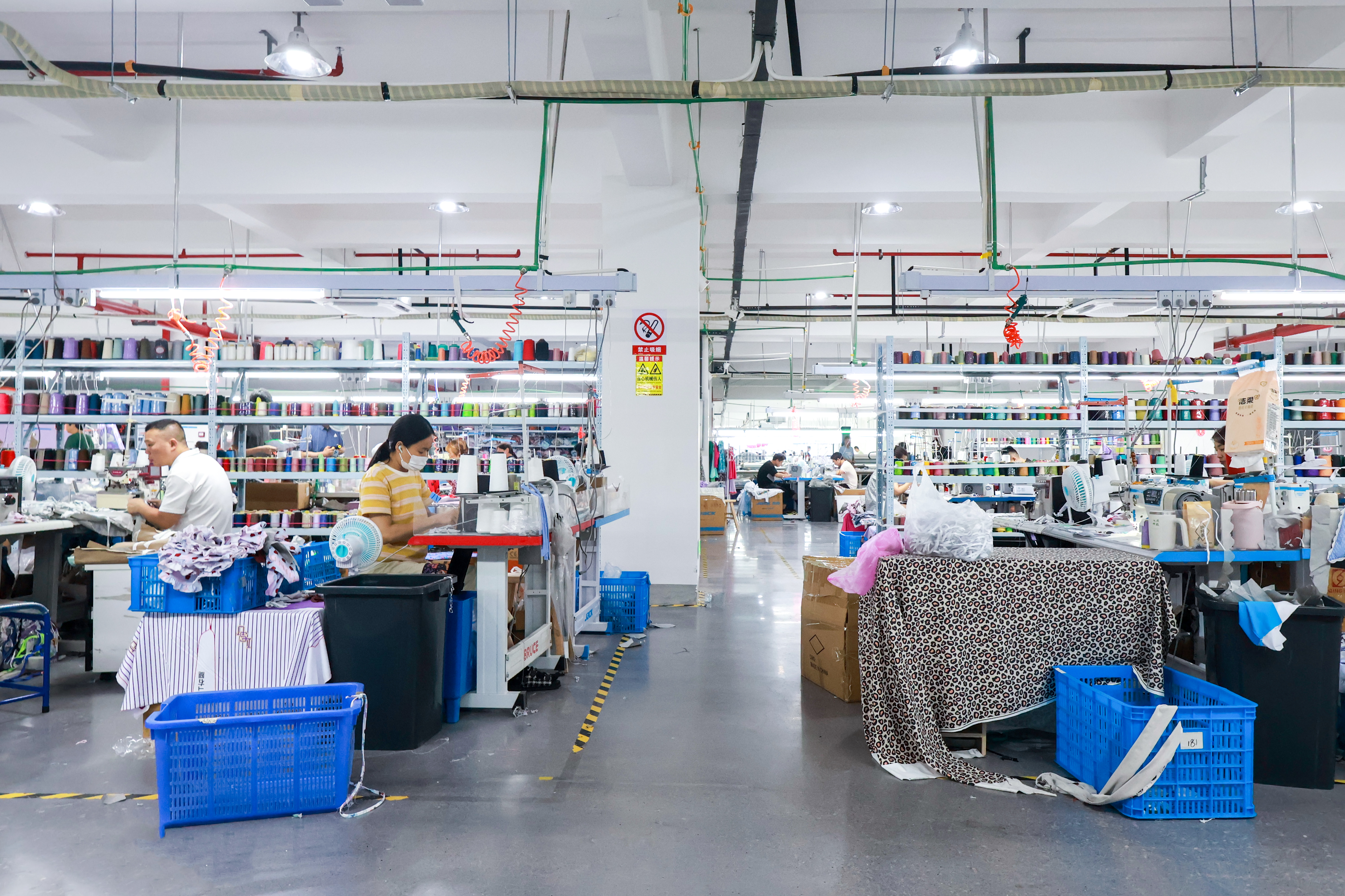 Sewing operators working across a garment production floor